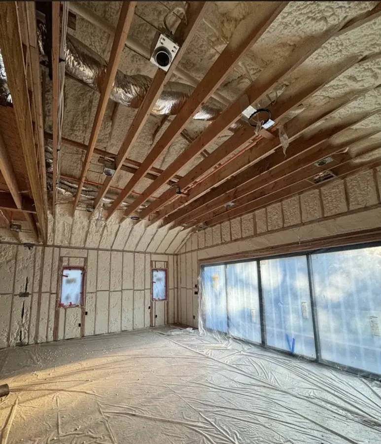 Interior walls and ceiling insulated with spray foam during new construction in Manhattan